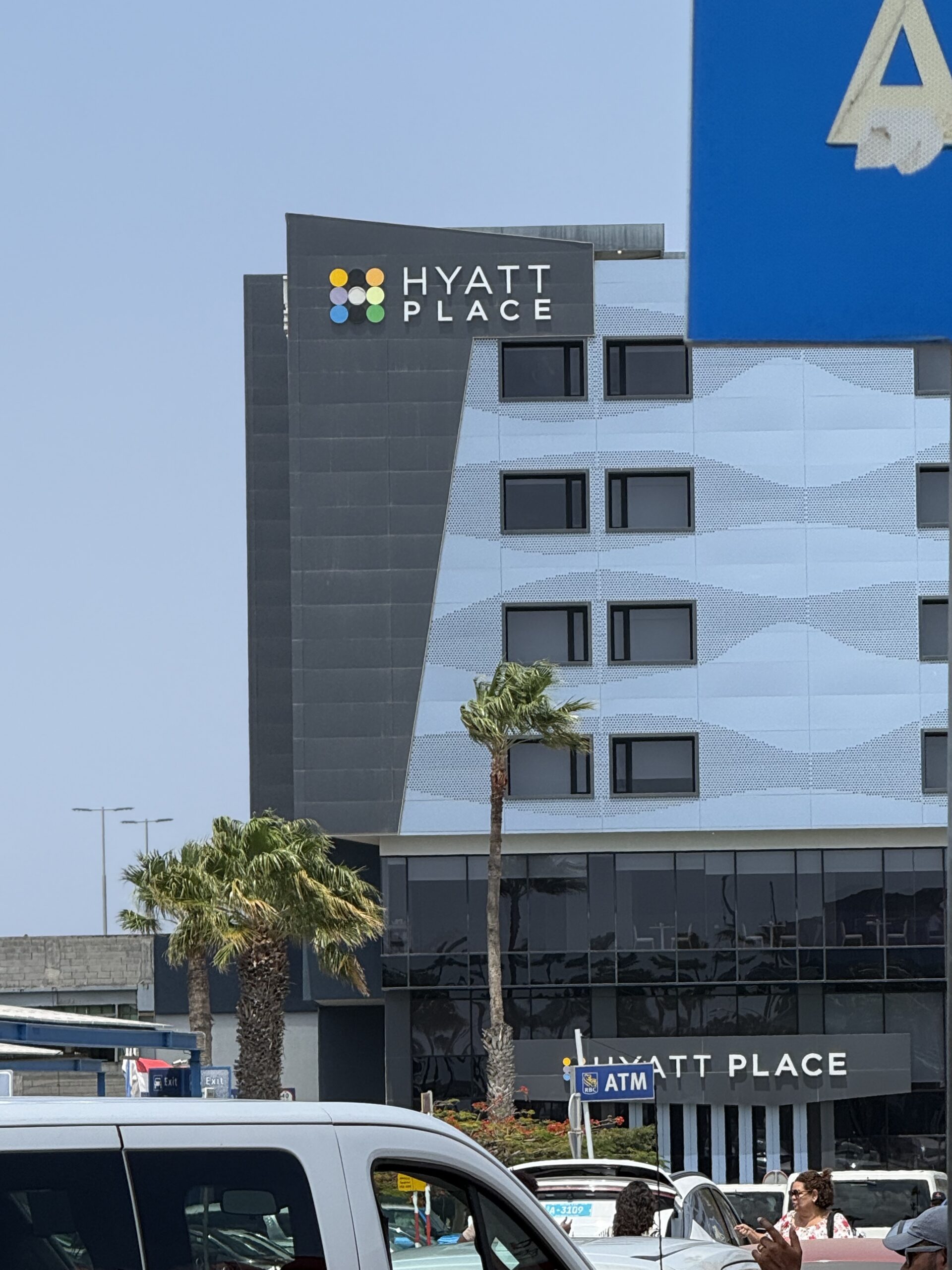 Hyatt Place Aruba Airport from the parking lot — the property is genuinely walking distance from Queen Beatrix Airport arrivals