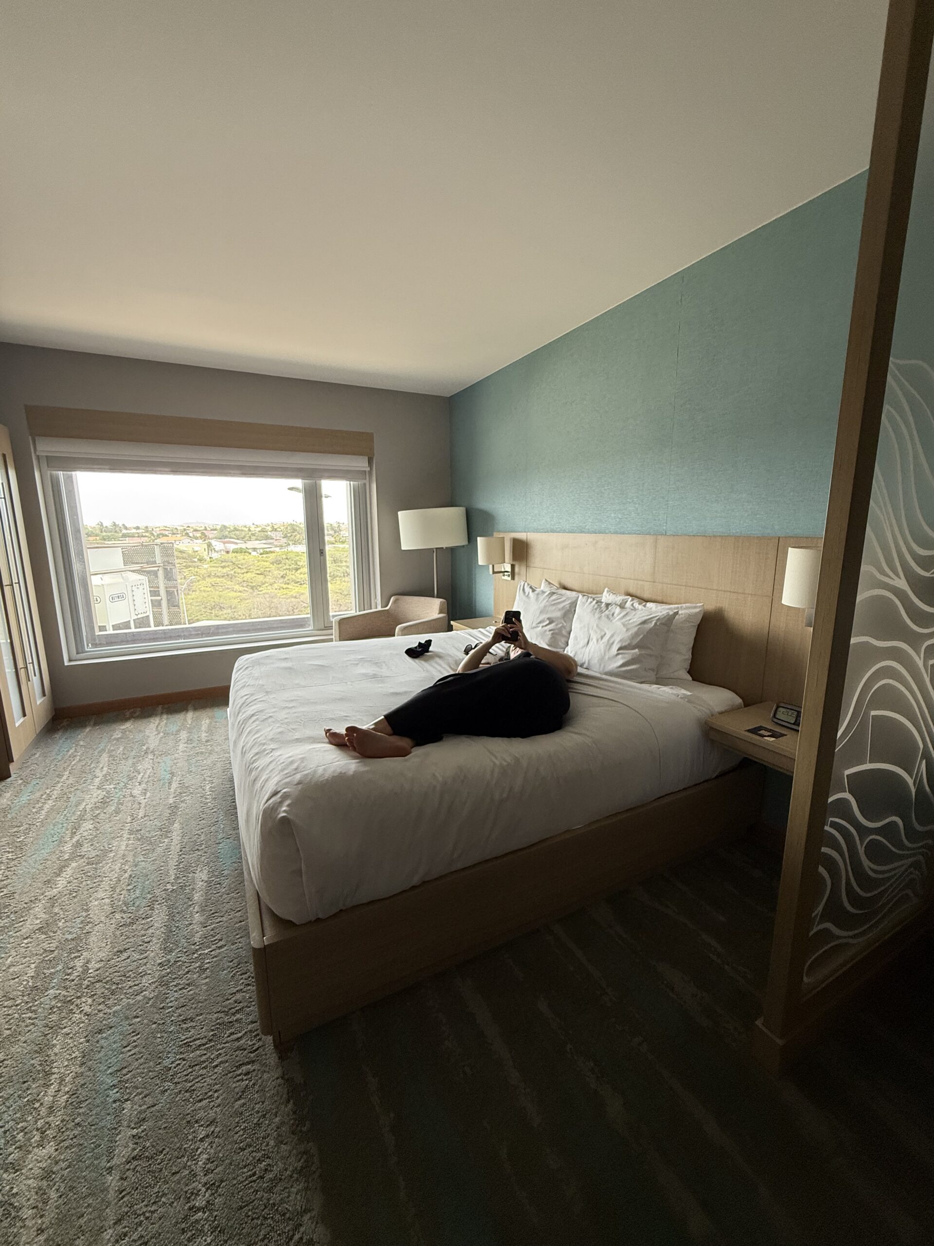 The bedroom side of the suite — that big picture window looks out over Wayaca and you could see planes on the runway from here