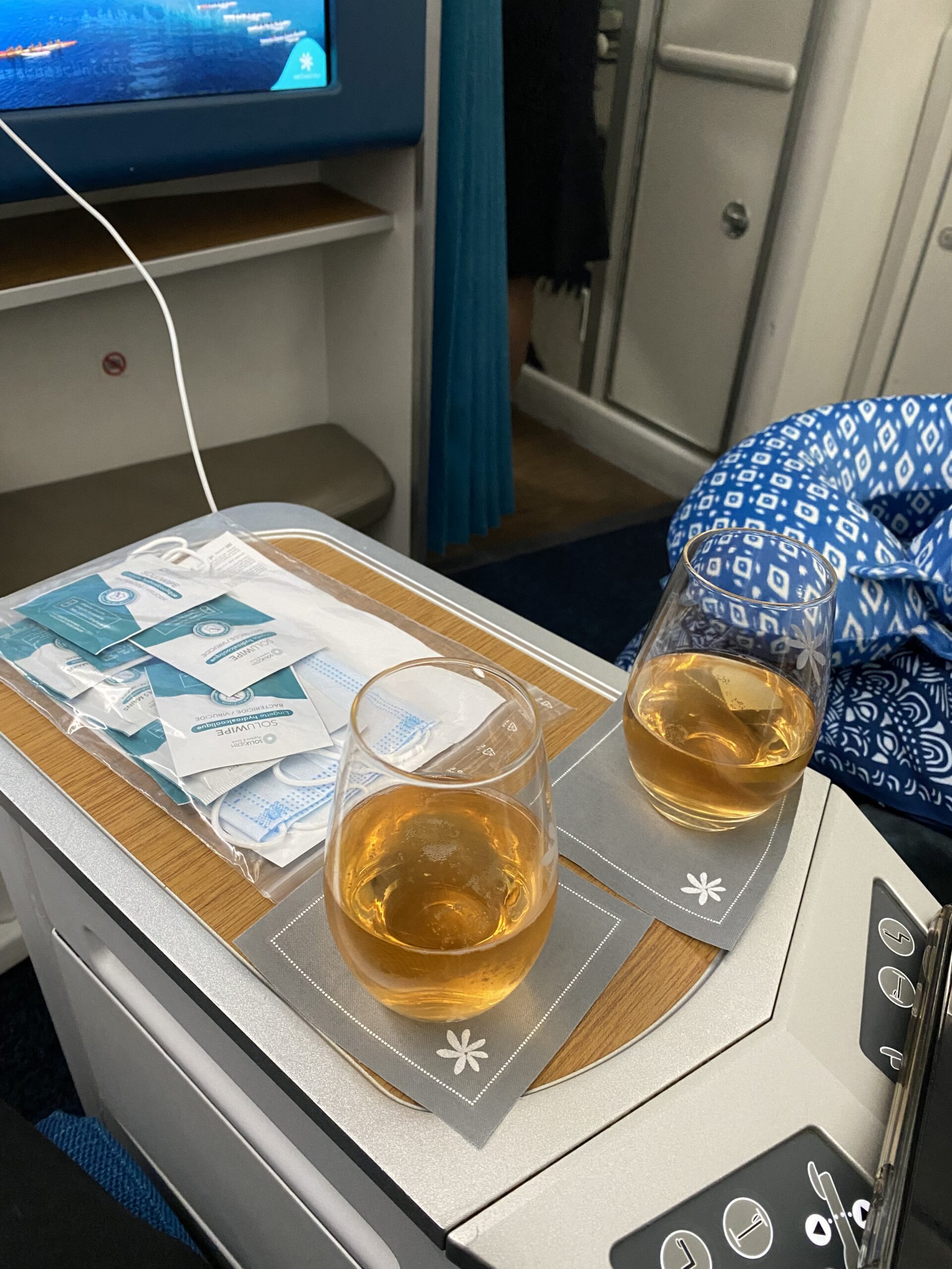 Two glasses of Charles Heidsieck Brut Reserve champagne on our shared console right after boarding — the first thing that told me we'd made the right call