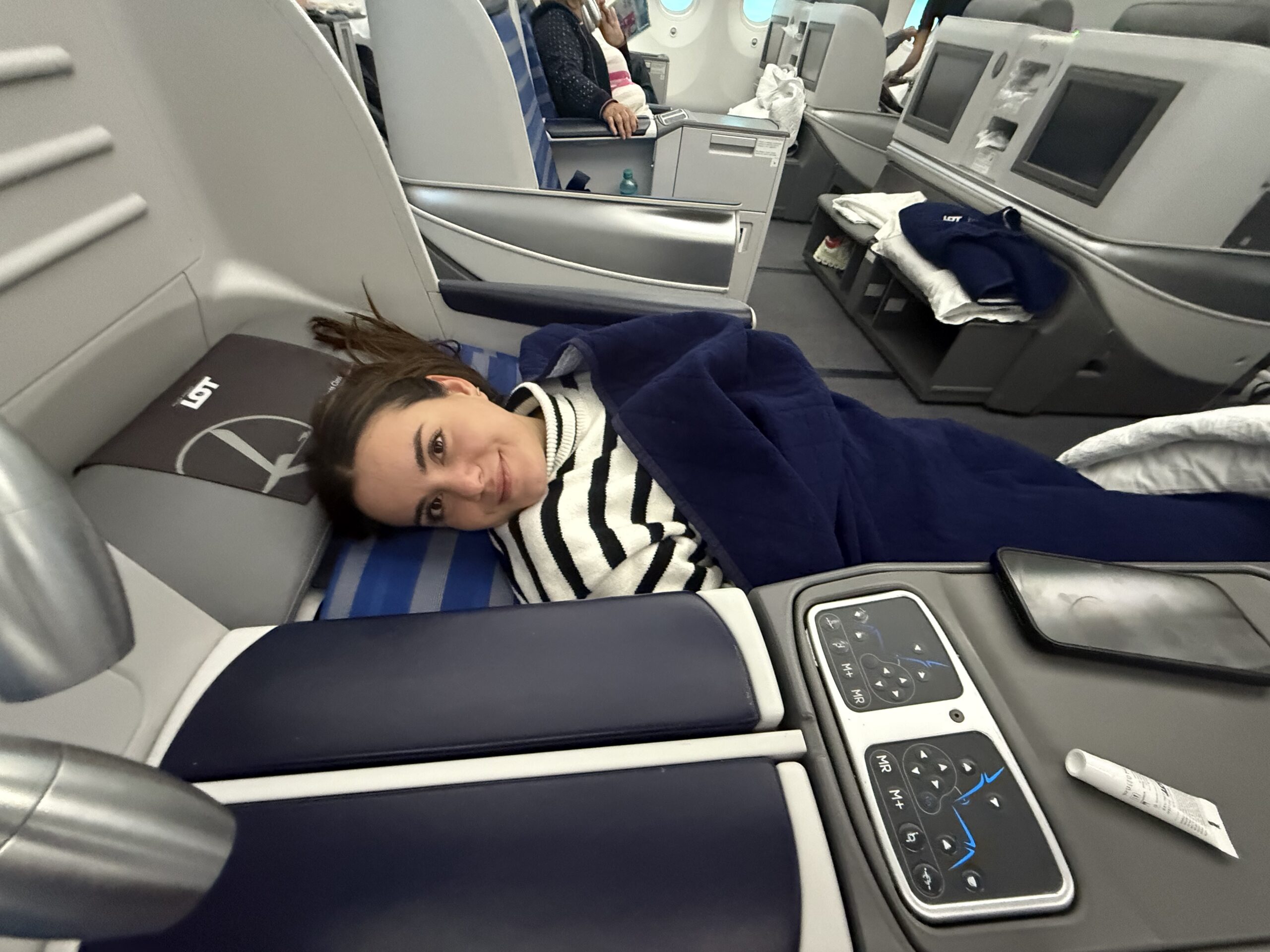 The LOT 787 business class bed in use, showing the 2-2-2 layout and LOT-branded pillow
