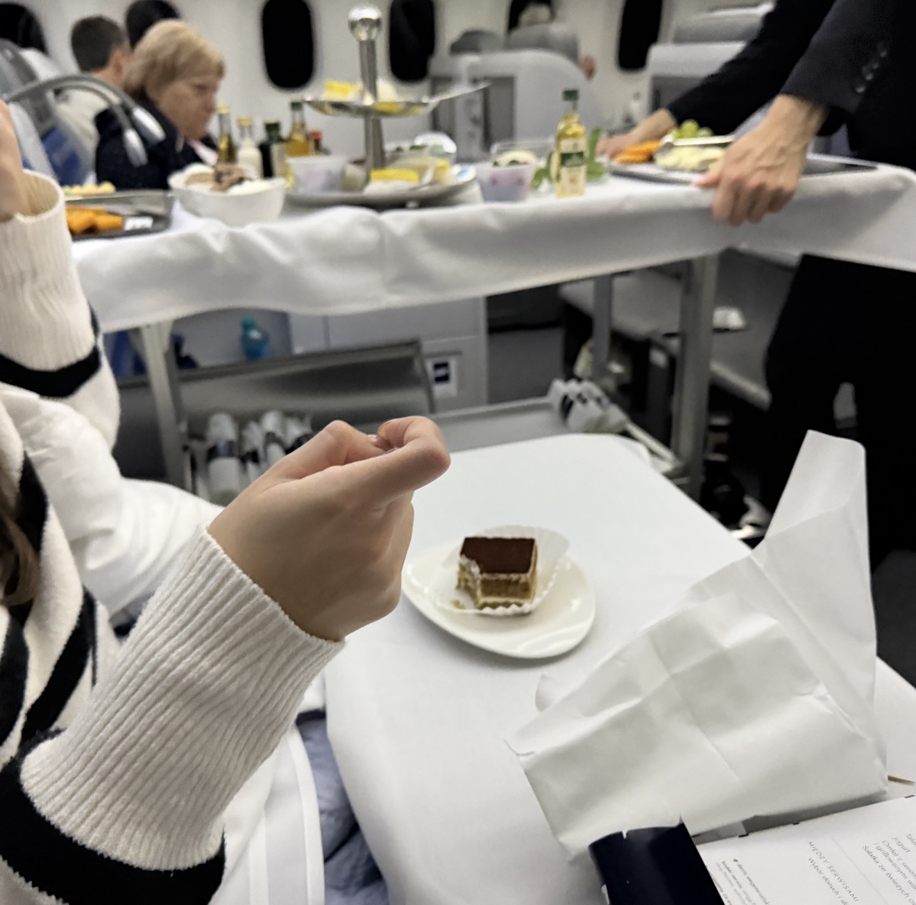 Tiramisu served from a linen-covered trolley in the aisle of LOT 787 business class